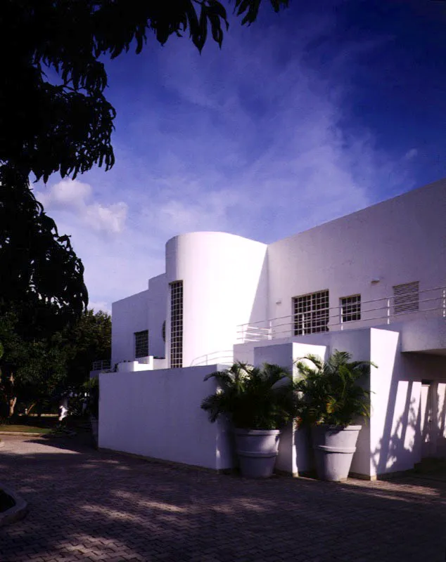 La teoría del blanco sobre blanco aplicada en el exterior y en el interior de la casa es propia de una concepción arquitectónica inspirada en el racionalismo contemporáneo. La pequeña excepción de color se introduce como elemento de contraste sin alterar el monocromatismo imperante. / Anapoima, Cundinamarca. Arquitecto, Alberto Valovis.