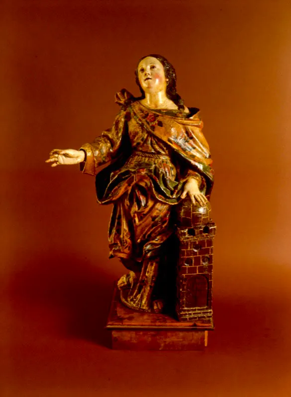 Annimo.
	Santa Brbara. Siglo XVIII.
	Talla en madera policromada.
	Ojos de vidrio. Rostro de estao.
	64 x 39 x 24 cm.
 