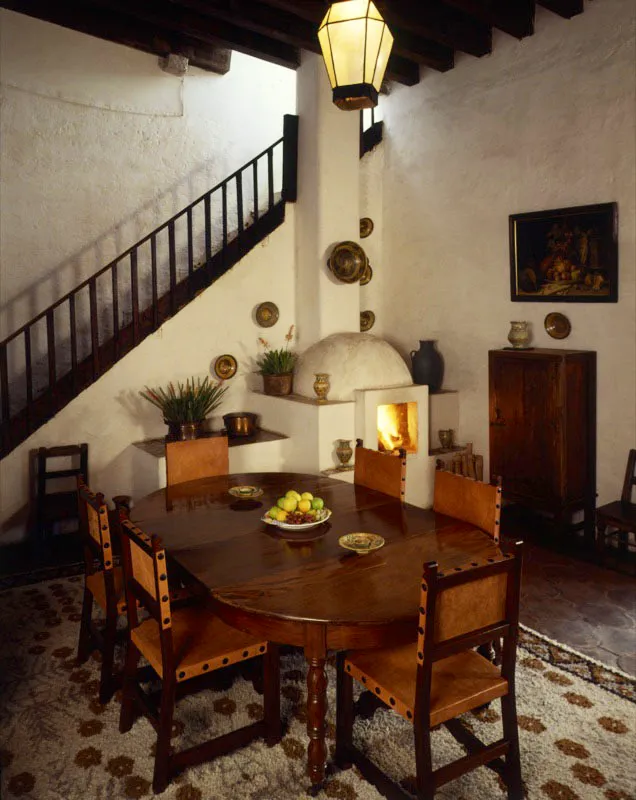 Comedor de estilo español de la casa, donde se ha incorporado una chimenea y decorado con platos de mayólica antigüeña.
