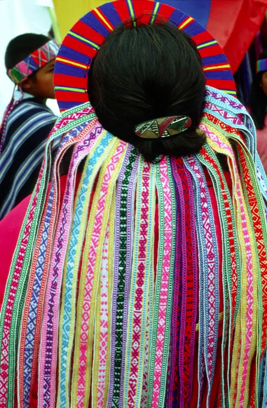 Mujer inga luce corona adornada de chumbes.