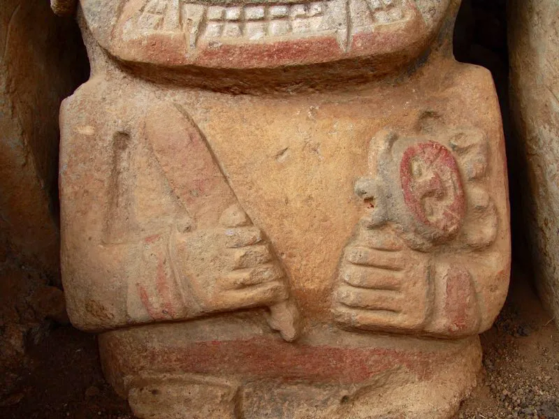 Detalles de estatuas de personajes con los implementos para la masticación de hojas de coca, a saber, una varita, en la mano derecha, y en la izquierda un recipiente que guarda cal, que adherida a la varita se lleva a la boca para la extracción de los alcaloides de la coca. Una de las estatuas de colores del alto de El Purutal en lugar de recipiente lleva bajo el brazo un bebé que, como todas las figuras infantiles de la estatuaria, tiene los ojos cerrados, y corona su cabeza una prolongación cuadrangular, obviamente la boca del recipiente. Surge así una nueva imagen chamanística en el arte de Macizo Colombiano: el bebé-poporo.